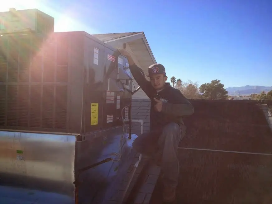 HVAC technician performing HVAC Inspection on a rooftop unit in Arkadelphia